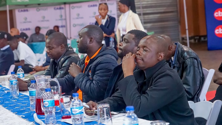 A row of guests seated at a table during the event.