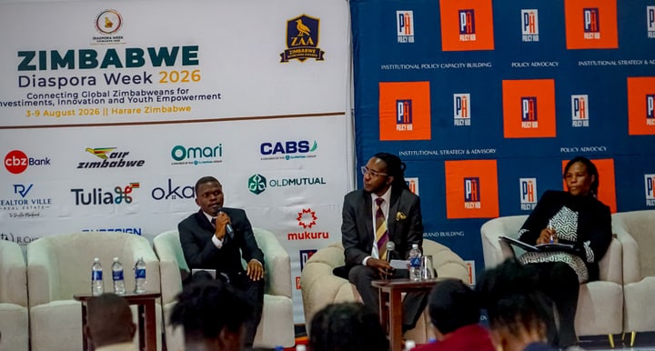 Three participants seated on stage beside Zimbabwe Diaspora Week 2026 and Policy Hub banners.