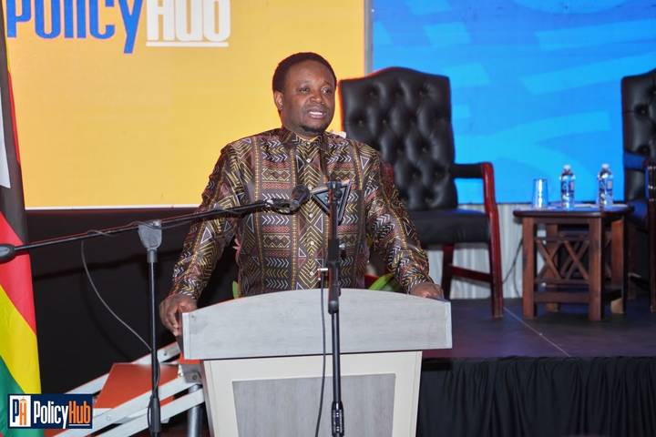 Speaker delivering an address at a Policy Hub podium