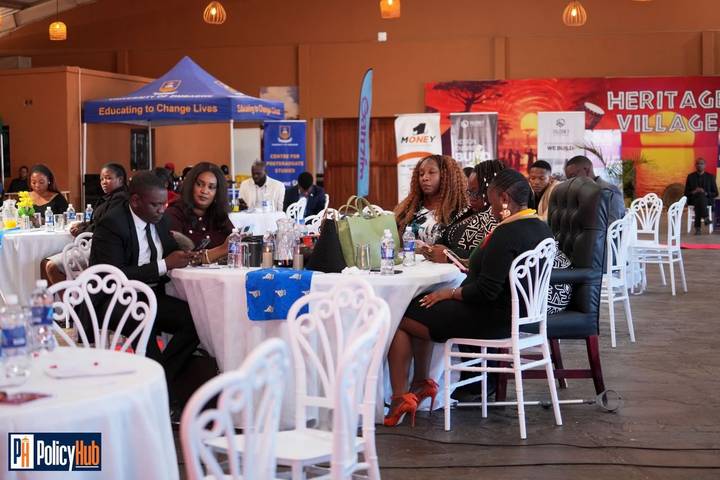 Stakeholders seated around tables at the Policy Expo